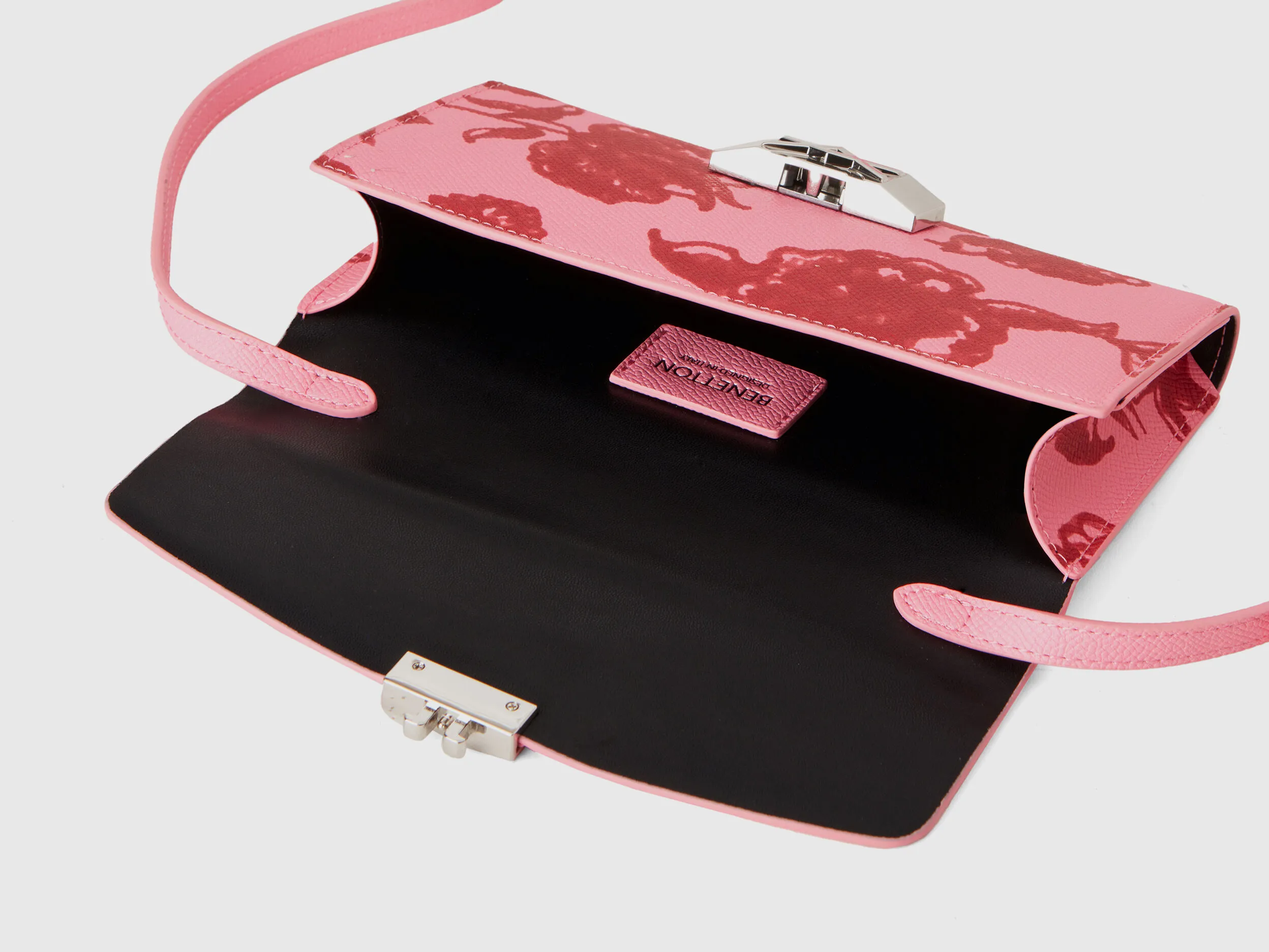 Bolso portamóvil rosa pastel con estampado floral